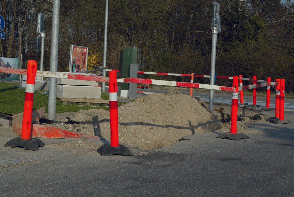 Plastic barrier stanchion with holes for board